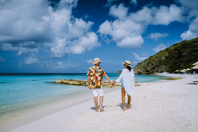 Cas Abou Beach Curacao on the caribbean island of Curacao, Playa Cas Abou in Curacao Caribbean tropical white beach with blue ocean men and woman on the beach, couple mid age on vacation