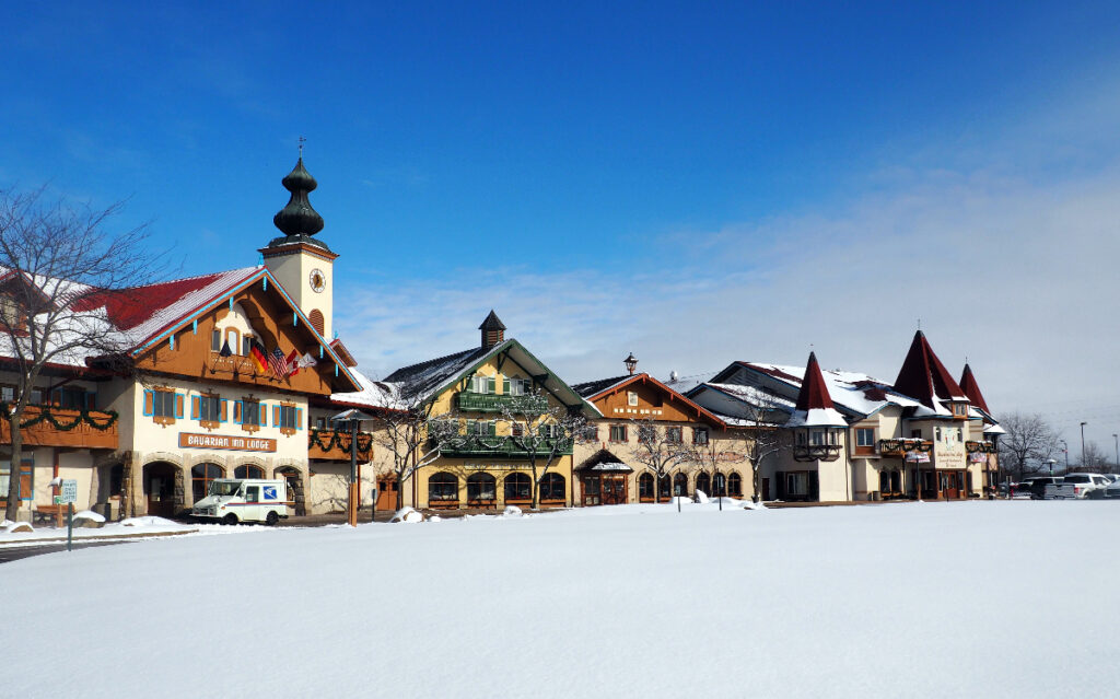 Frankenmuth, MI / USA - February, 7, 2020: Bavarian-style houses of the Bavarian Inn center on a perfect winter day. Blue sky above and white snow on the ground. No people. Simply beautiful.